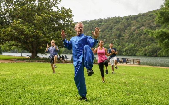 Tai Chi class outdoor with the lake in the back
