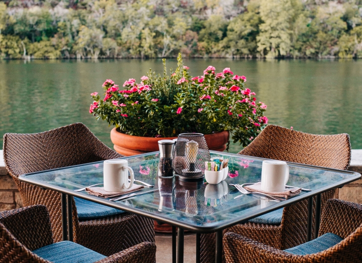 A set of one tables and chairs outdoor by the lake
