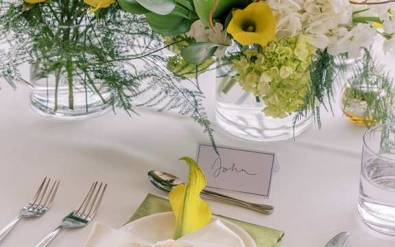 A table set up with flowers and elegant dining utensil