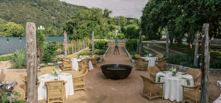 Tables arranged in the garden by the lake