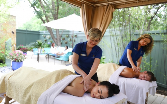 two women get massaged by two massage therapists
